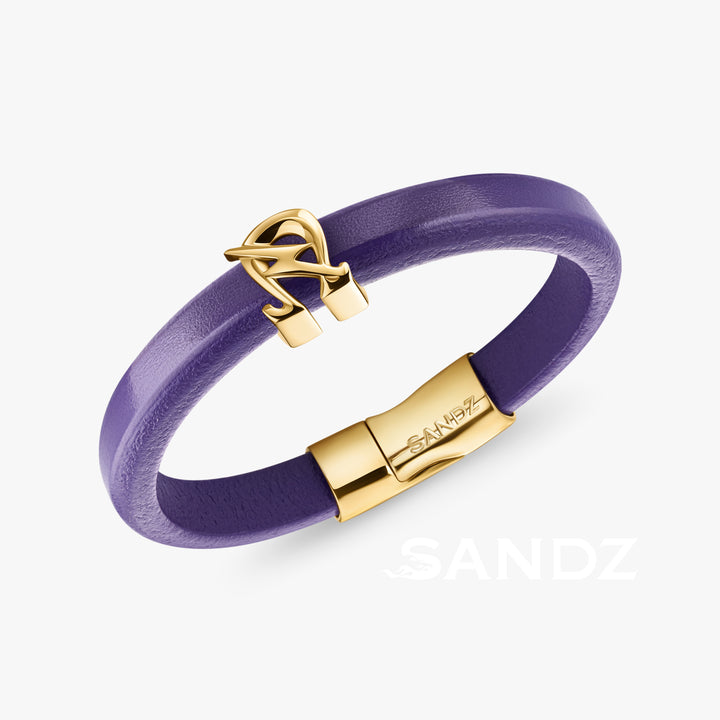 A purple leather bracelet with a gold-plated stainless steel Omega Lighting Bolt charm and a secure Greek letter attachment.